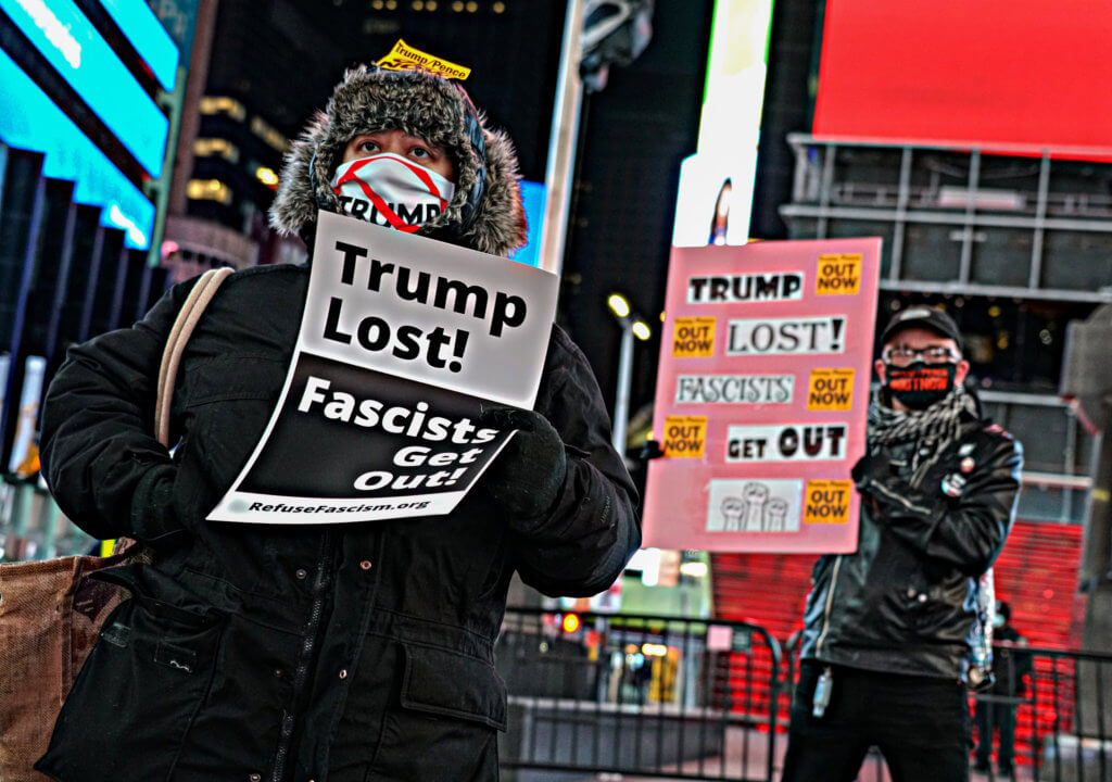 Demonstrators descend on Trump Hotel, call for daily protests