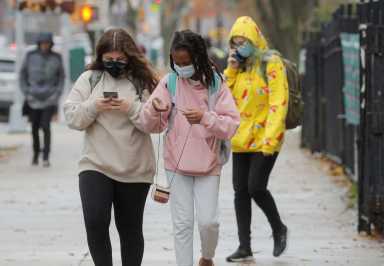 Students exit a school as the spread of coronavirus disease (COVID-19) continues, in Brooklyn, New York