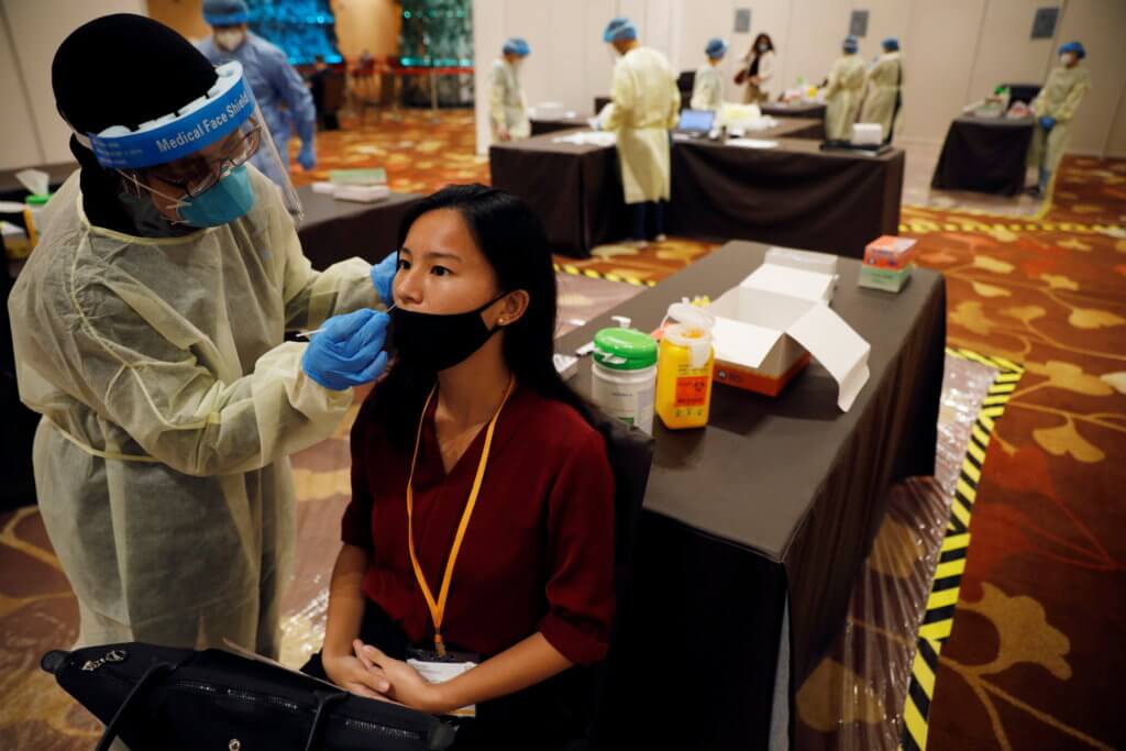 An attendee receives a nose swab as part of a coronavirus disease (COVID-19) antigen rapid test before a conference held by the Institute of Policy Studies at Marina Bay Sands Convention Centre in Singapore