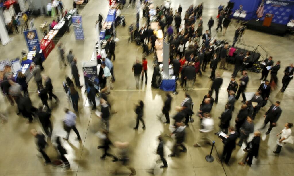 FILE PHOTO: Job seekers break out to visit employment personnel at “Hiring Our Heroes” military job fair in Washington