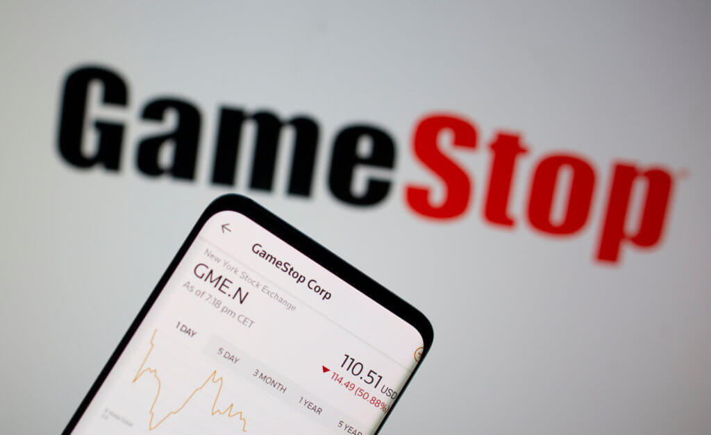 FILE PHOTO: GameStop stock graph is seen in front of the company’s logo