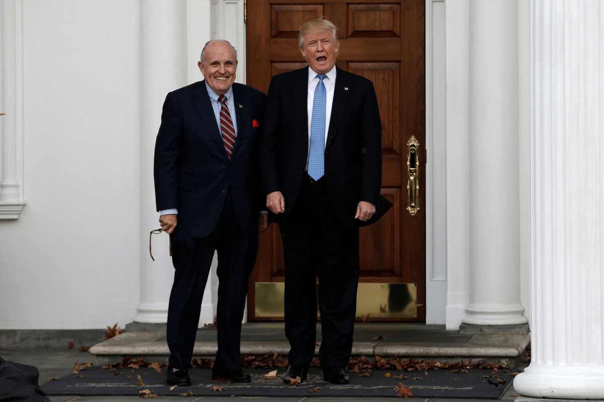 U.S. President-elect Donald Trump stands with former New York City Mayor Rudolph Giuliani before their meeting at Trump National Golf Club in Bedminster
