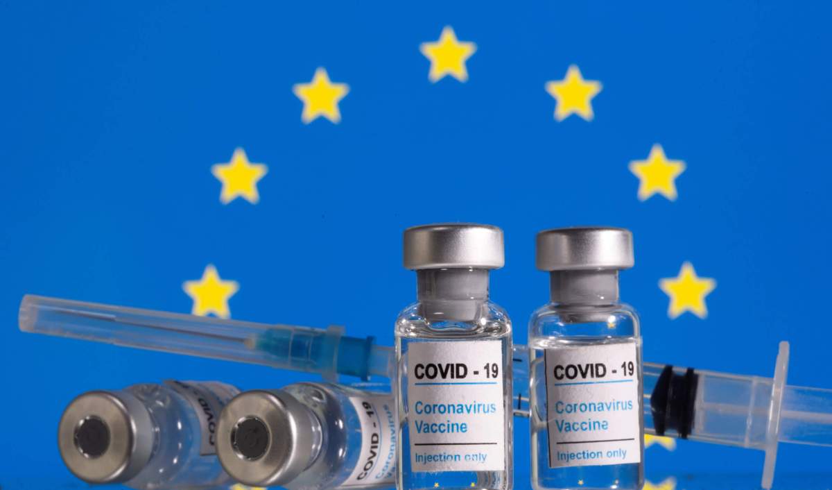 FILE PHOTO: Vials labelled “COVID-19 Coronavirus Vaccine” and sryinge are seen in front of displayed EU flag in this illustration