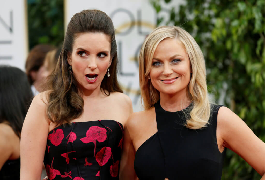 FILE PHOTO: Golden Globes hosts Tina Fey and Amy Poehler pose at the 71st annual Golden Globe Awards in Beverly Hills