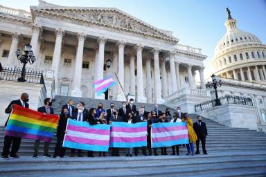 Democratic members of the U.S. House of Representatives pose for a photograph holding LBGT+ and Transgender Pride flags on the steps of the U.S. Capitol ahead of a vote on the Equality Act on Capitol Hill in Washington
