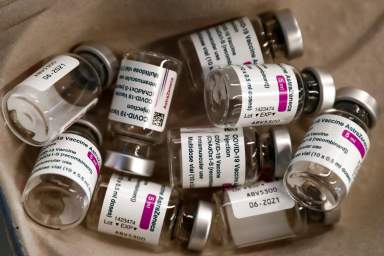FILE PHOTO: Empty vials of AstraZeneca COVID-19 vaccine are seen in a tray