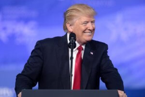 President Donald Trump smiling at a podium