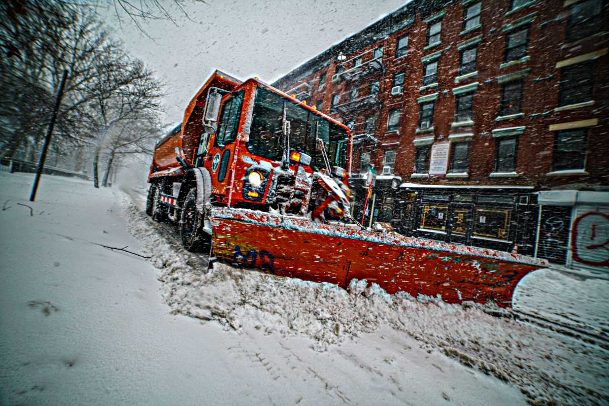 Sanitation Department snow plow at work during a winter storm