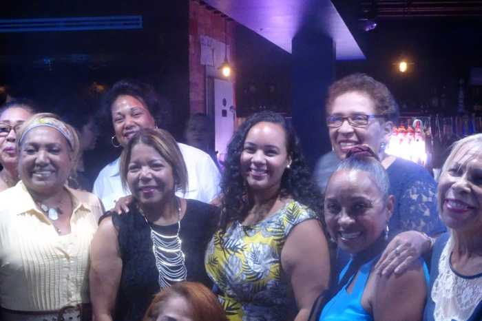 Carmen De La Rosa poses with several of her constituents (photo by William Engel)