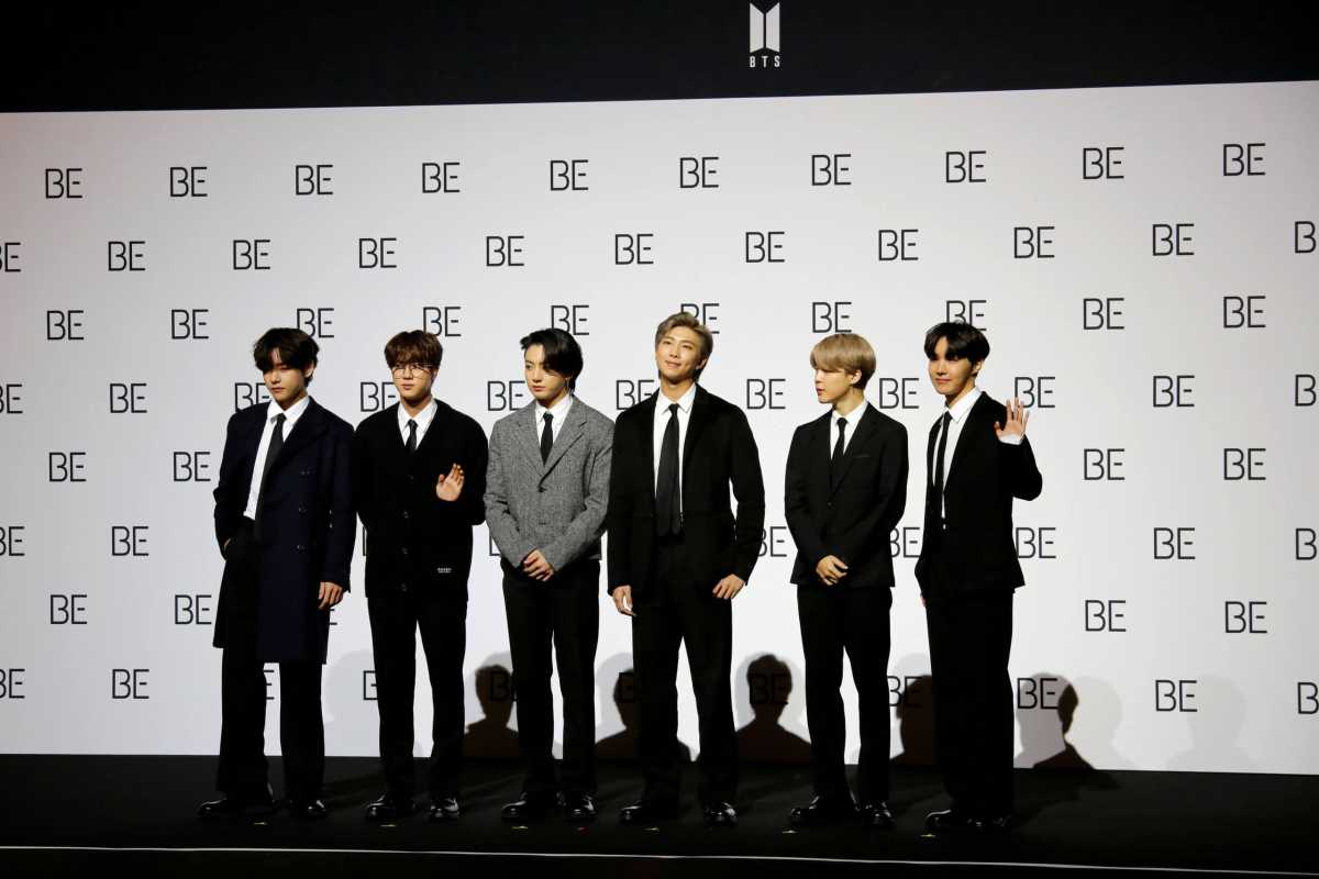 FILE PHOTO: Members of K-pop boy band BTS pose for photographs during a news conference promoting their new album “BE(Deluxe Edition)” in Seoul