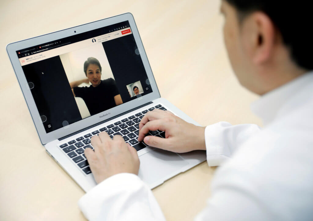 FILE PHOTO: Medical doctor Makoto Kitada demonstrates a telemedicine application service called ‘CLINICS’, in Tokyo