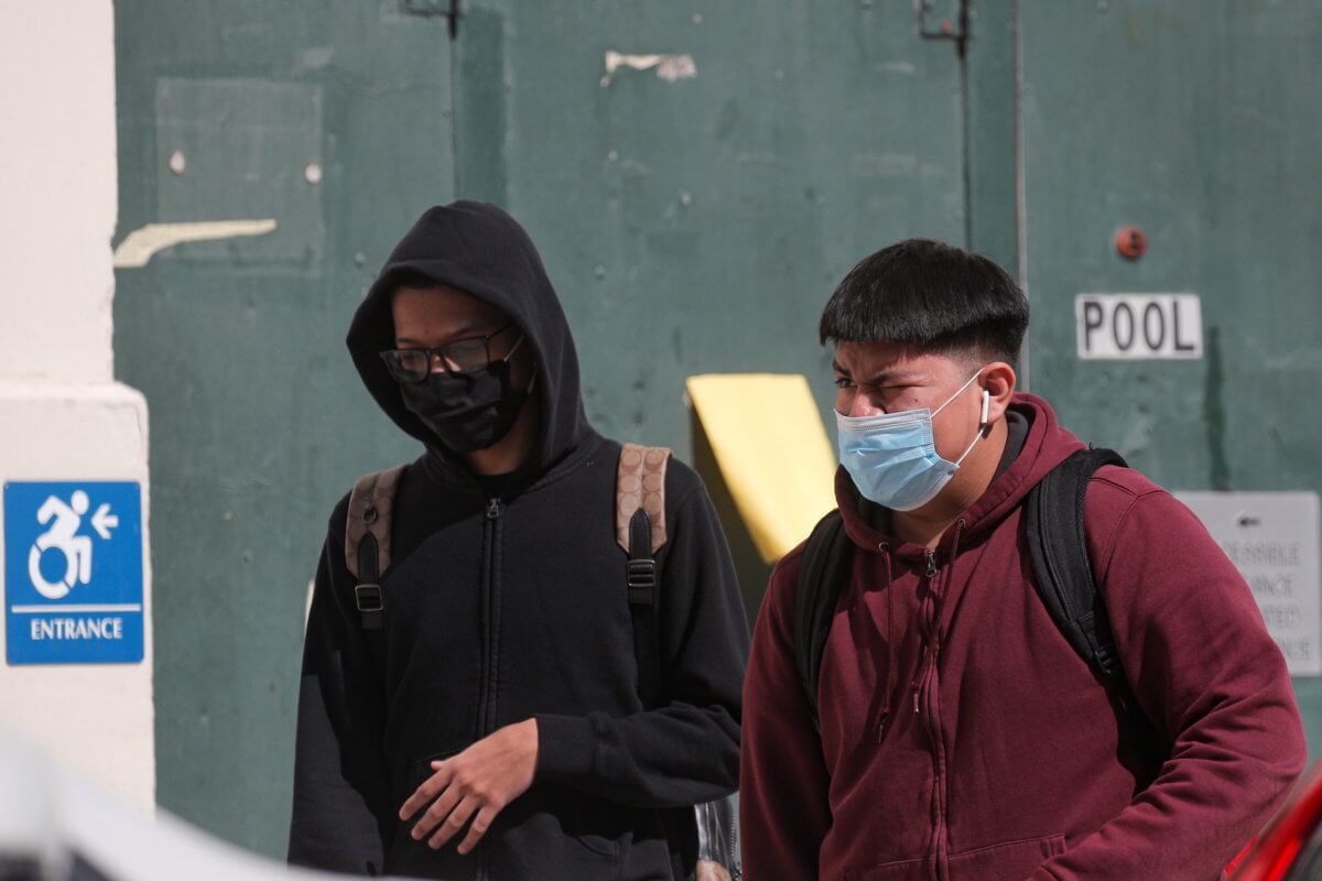 Students exit following the return to in-person learning for New York City High School students, as the global outbreak of the coronavirus disease (COVID-19) continues, at John Jay High School in Brooklyn, New York