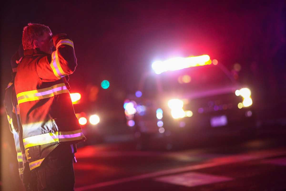First responders stand in salute as a procession of law enforcement vehicles drive past in honor of fallen Boulder police officer Eric Talley, who was shot and killed by a gunman at a King Soopers grocery store in Boulder