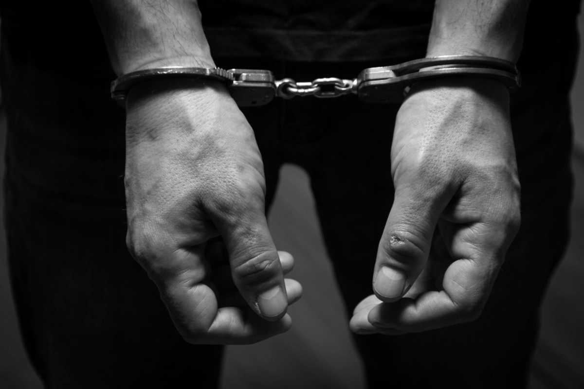 The arrested criminal handcuffed