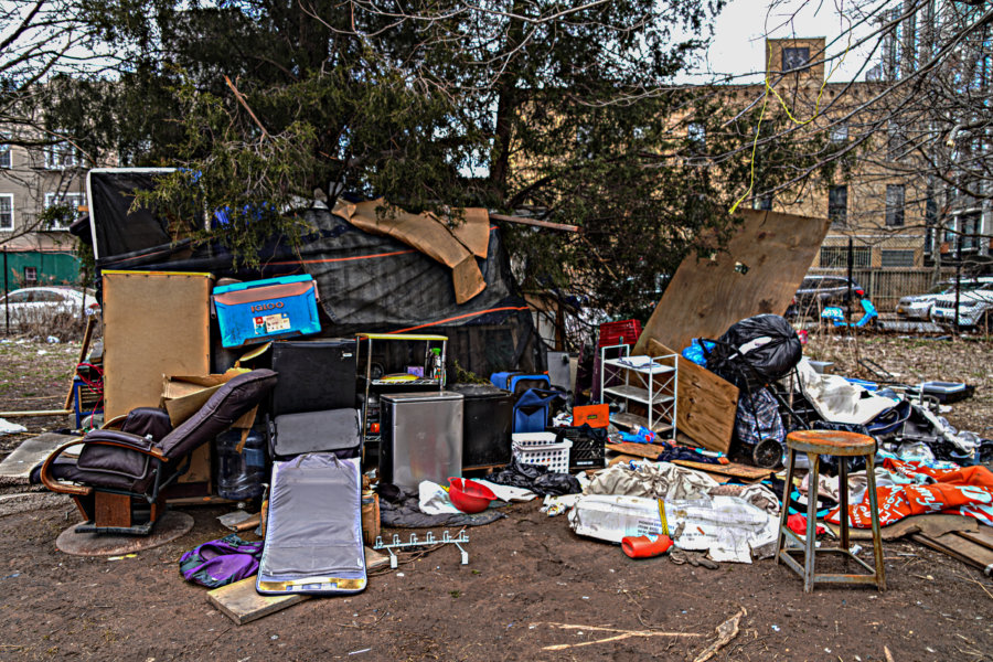 Sign of the times A homeless encampment rises amid traffic near the
