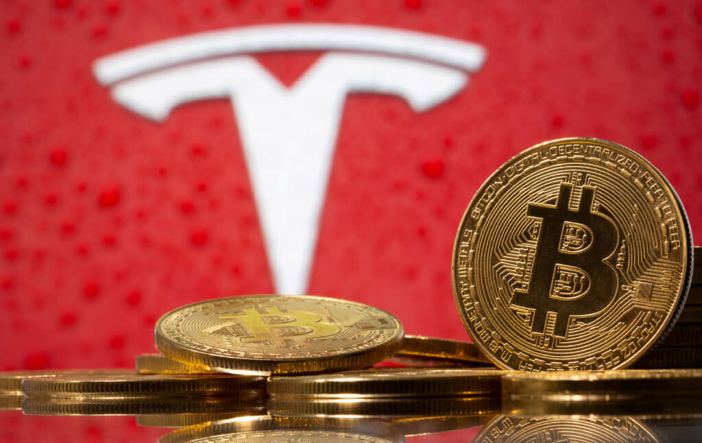 FILE PHOTO: Representations of virtual currency Bitcoin are seen in front of Tesla logo in this illustration