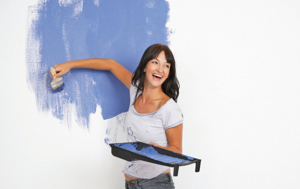 Woman painting and laughing