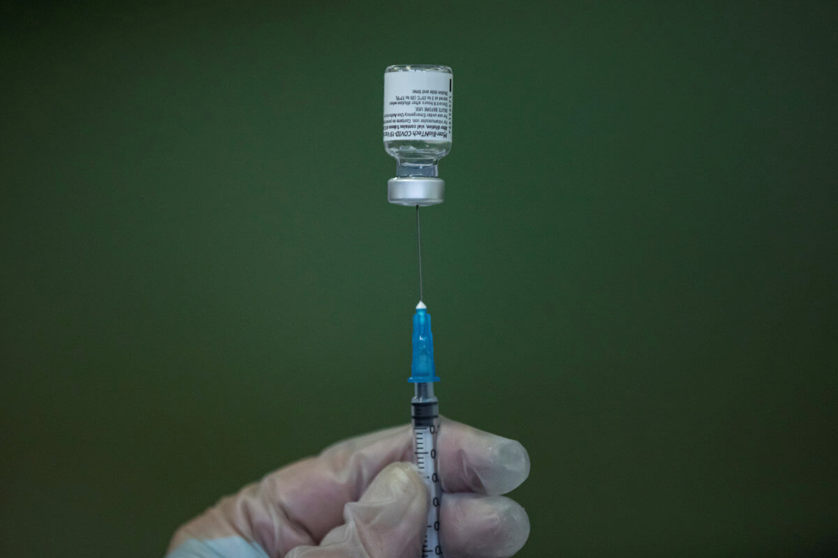 FILE PHOTO: A medical worker fills a syringe with Pfizer-BioNTech vaccine in Nis, Serbia