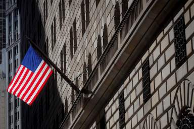 A U.S. flag flies outside The Federal Reserve Bank of New York in New York