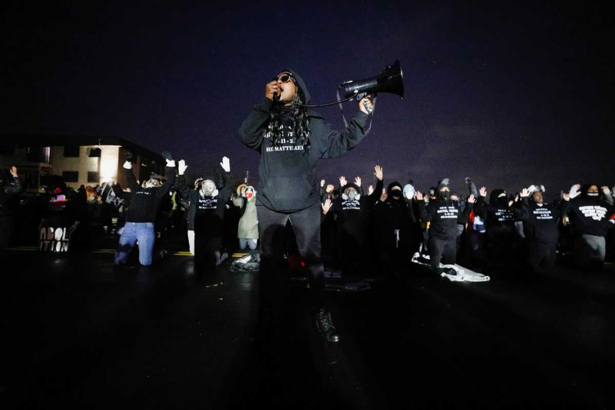 Activists confront officers following a march for Daunte Wright, who was shot and killed by former Brooklyn Center Police Officer Kim Potter, in Brooklyn Center, Minnesota
