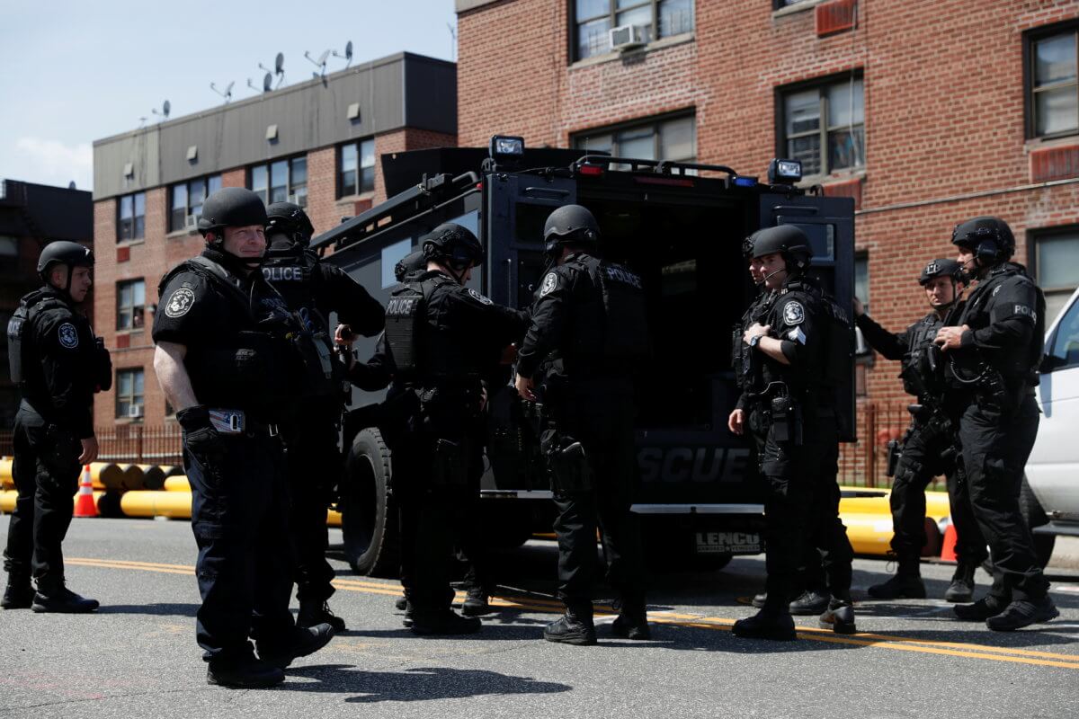Law enforcement officers stand near the place where the shooter barricaded himself, after a shooting at a Stop and Shop grocery store, in Hempstead