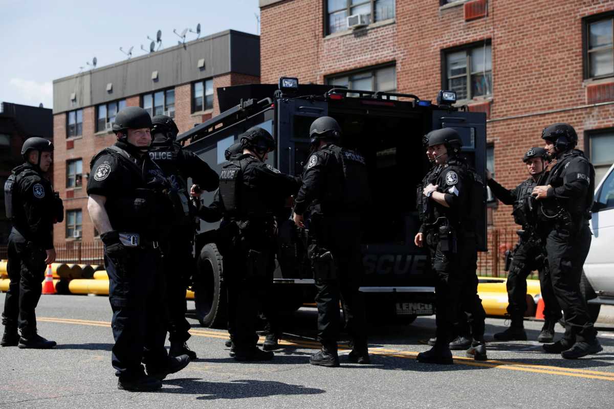 Law enforcement officers stand near the place where the shooter barricaded himself, after a shooting at a Stop and Shop grocery store, in Hempstead