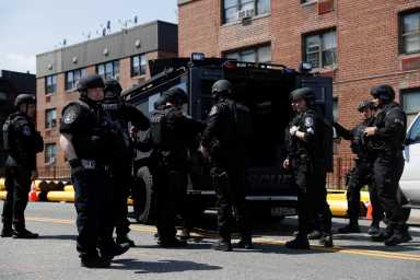 Law enforcement officers stand near the place where the shooter barricaded himself, after a shooting at a Stop and Shop grocery store, in Hempstead
