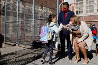Meisha Porter, Chancellor of the New York City Department of Education, greets students as they return to school in Manhattan, New York