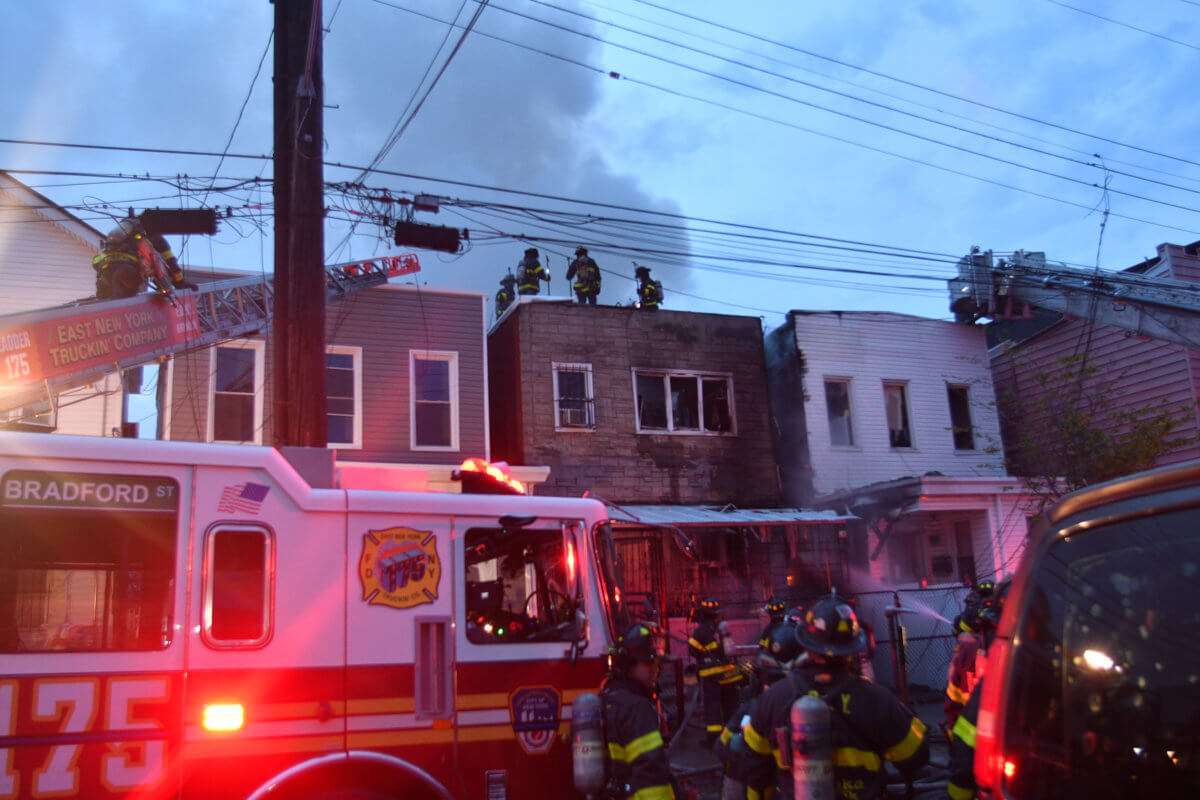 Firefighters work to contain a two alarm fire at 323 Cresent Street.