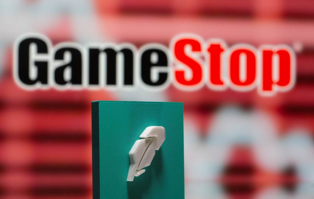 A 3d printed Robinhood logo is seen in front of displayed GameStop logo in this illustration