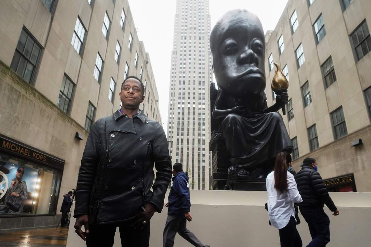 Sanford Biggers poses for a photo in front of his statue ‘Oracle’ in New York City