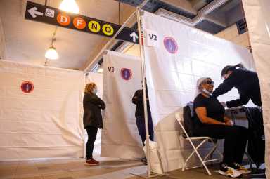 A commuter receives free vaccination for the coronavirus disease (COVID-19) at the Coney Island subway station in Brooklyn, New York