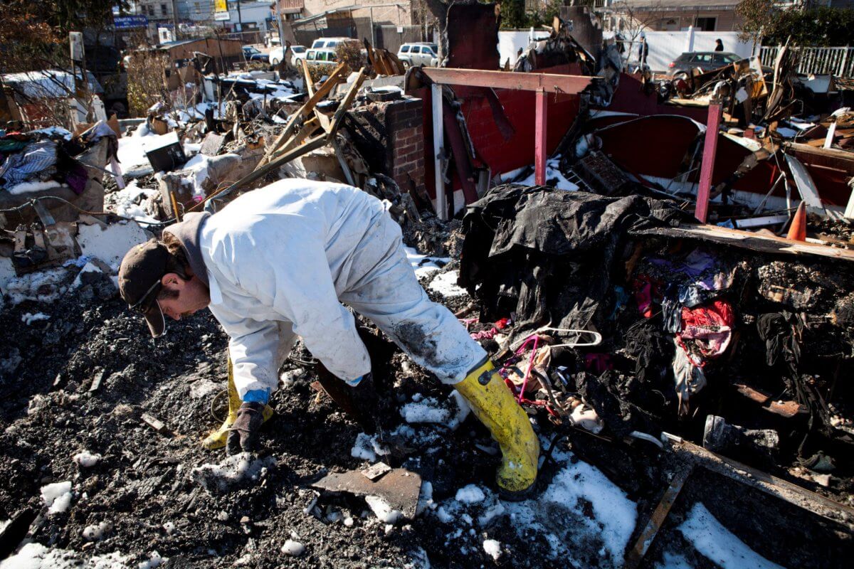 FILE PHOTO: Sylvester searches through remains of his house which was flooded and then burned to the ground during Hurricane Sandy for corpses of his five cats in Midland Beach neighborhood in Staten Island