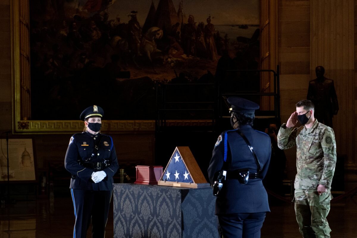FILE PHOTO: A member of the National Guard salutes while the remainsof Capitol Police officer Brian Sicknick lay in honor in the Rotunda of the U.S. Capitol building in Washington