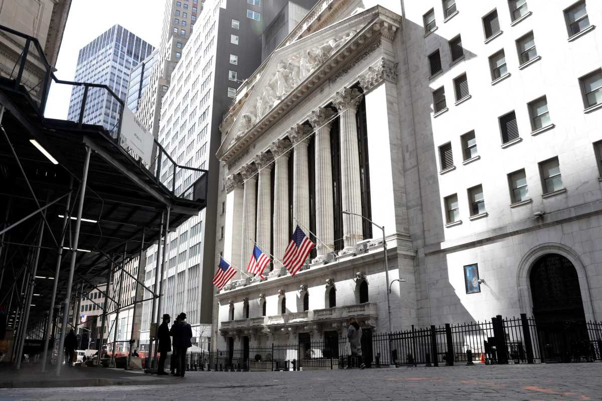 People are seen on Wall St. outside the NYSE in New York