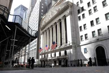People are seen on Wall St. outside the NYSE in New York