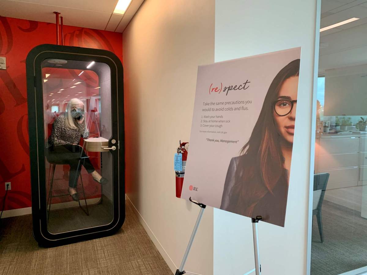 An employee makes a call in a newly-installed phone booth at real estate company JLL’s Austin office