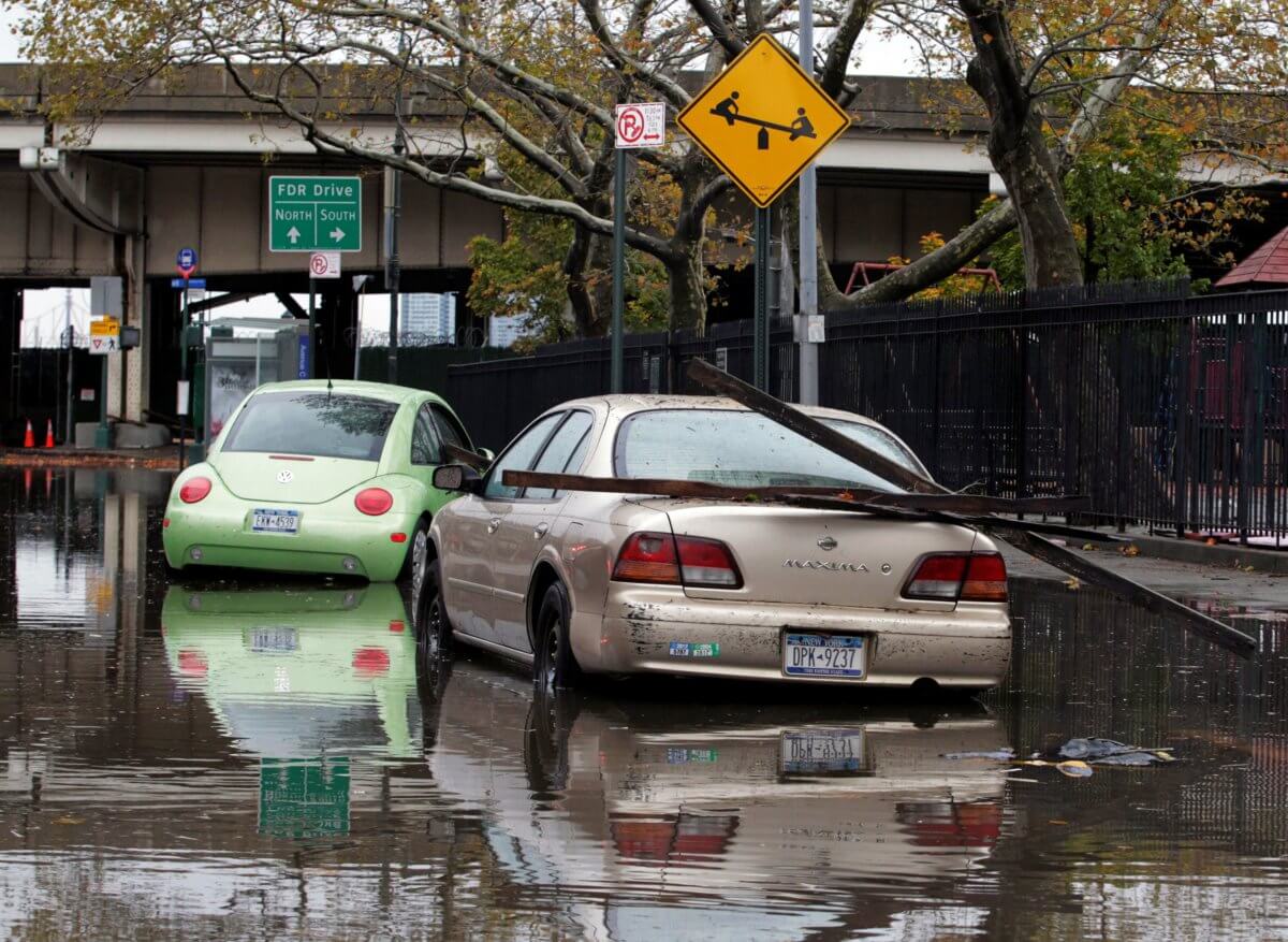 FILE PHOTO: Parked cars are partially submerged in flood waters in the aftermath of Hurricane Sandy in New York