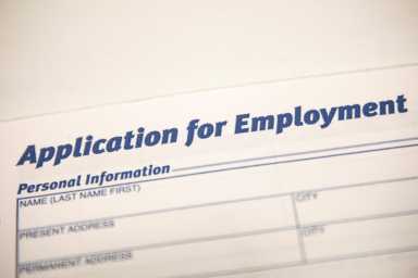 An employment application form is displayed during a restaurant job career fair in New York