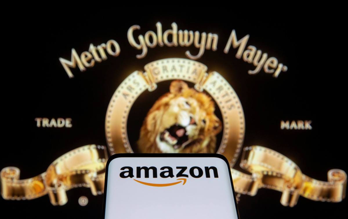 FILE PHOTO: Smartphone with Amazon logo is seen in front of displayed MGM logo in this illustration taken