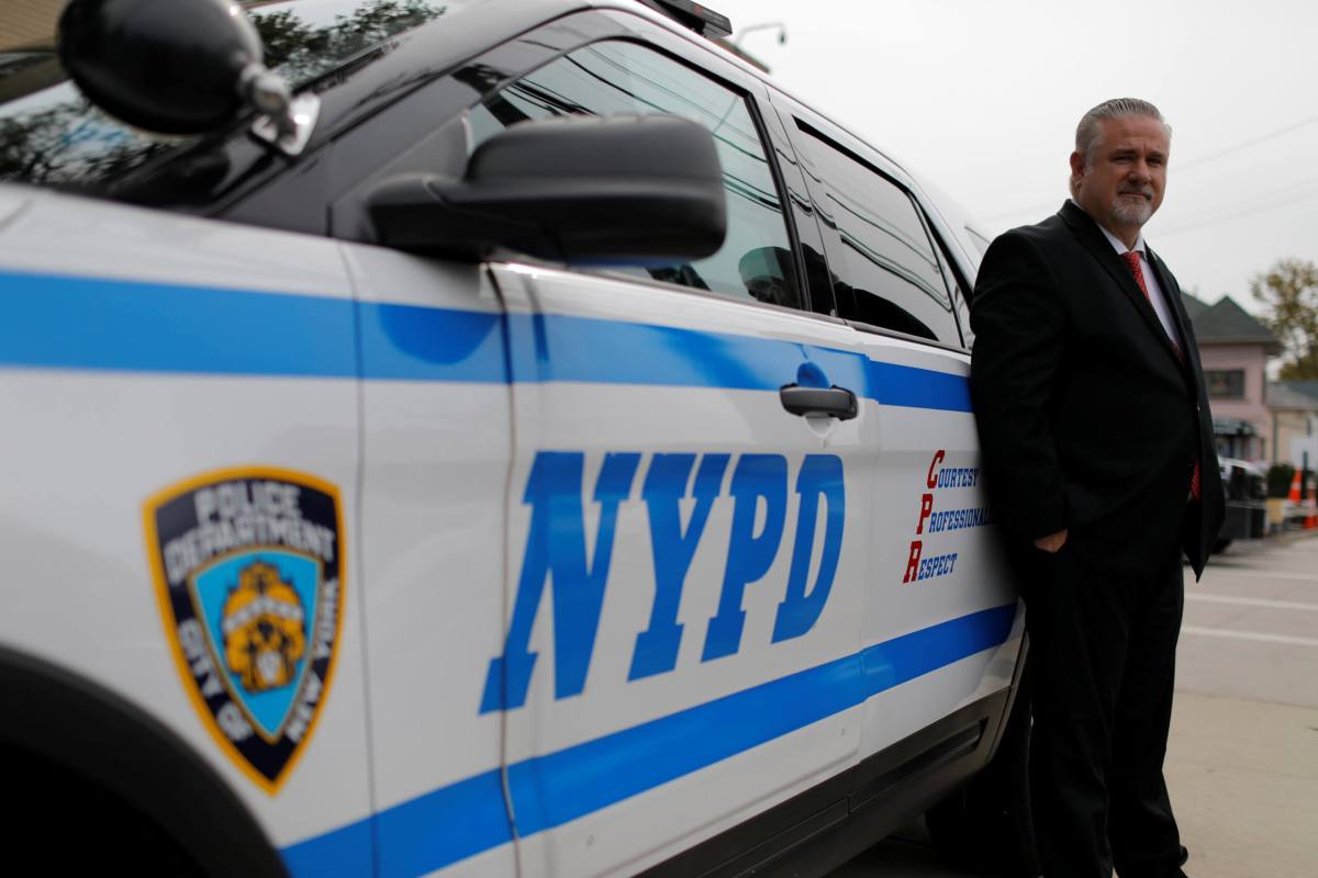 Detective Raymond Wittick, 51, a Staten Island Welfare Officer with the Detectives’ Endowment Association, poses with a New York Police Department (NYPD) vehicle on Staten Island in New York City