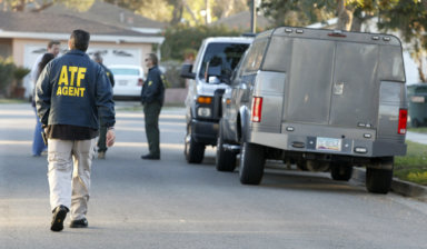 Police, FBI and Federal ATF agents prepare a robot to enter the home of William Lawrence Hunziker, 46, in Riverside, California