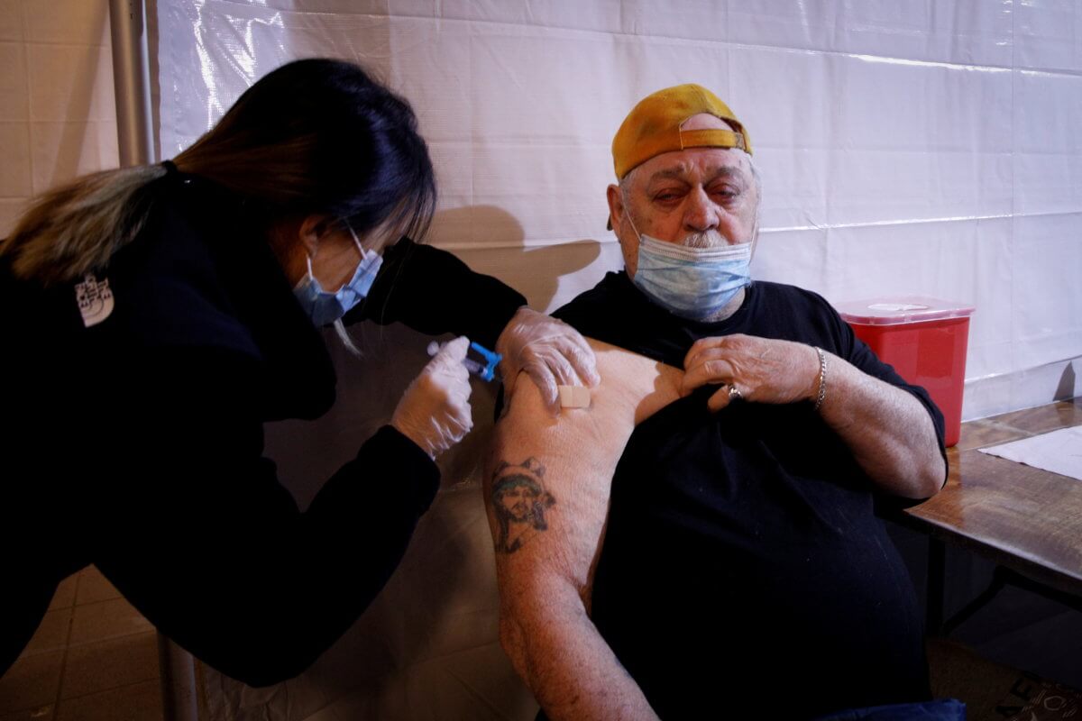 FILE PHOTO: Commuter receives free vaccination for the coronavirus disease (COVID-19) at subway station in Brooklyn borough of New York City