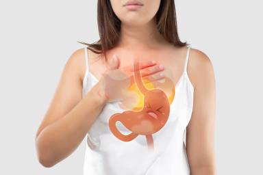 The Photo Of Cartoon Stomach On Woman’s Body Against White Background, Acid Reflux Disease Symptoms Or Heartburn, Concept With Healthcare And Medicine