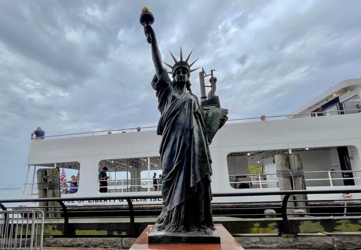 A replica Statue of Liberty is installed on Ellis Island across from her big sister in New York Harbor
