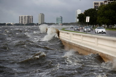 Waves crash the balustrades on Bayshore Boulevard after Hurricane Elsa churns up the Gulf coast, in Tampa