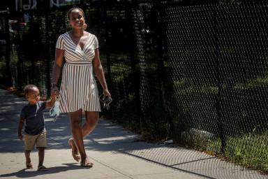 FILE PHOTO: Chantel Springer walks with her son Jasiah in the Brooklyn borough of New York