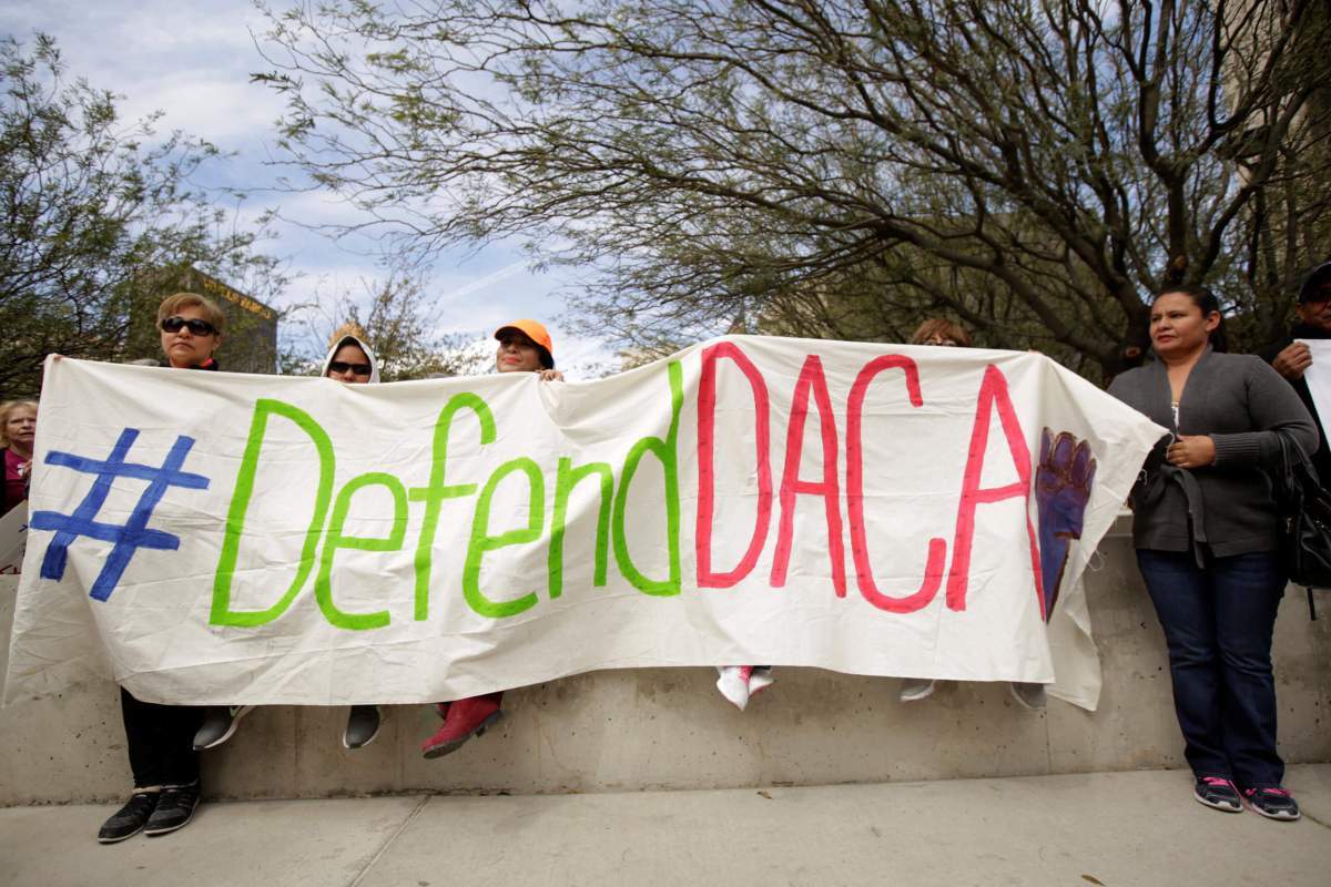 FILE PHOTO: Members of the Border Network for Human Rights and Borders Dreamers and Youth Alliance hold a banner during protest to demand that Congress pass a Clean Dream Act in El Paso