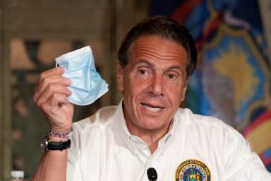 FILE PHOTO: New York Governor Andrew Cuomo discusses the wearing of masks as he speaks at a news conference about the East Side Access, in New York
