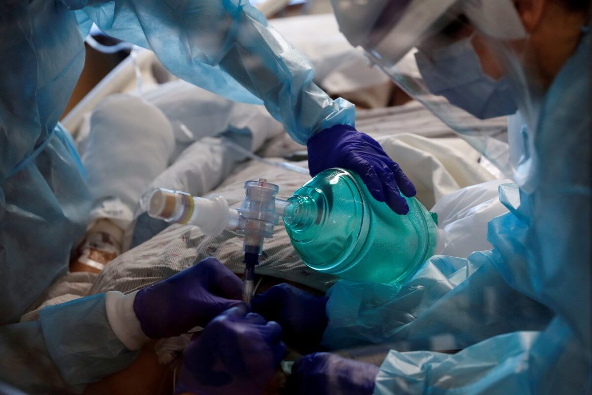 FILE PHOTO: Critical care workers insert an endotracheal tube into a coronavirus disease (COVID-19) positive patient in the intensive care unit (ICU) at Sarasota Memorial Hospital in Sarasota, Florida